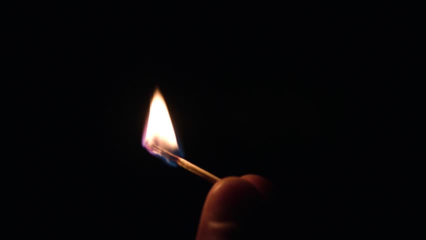 Match lighting and burning till the end and finally disappears from the flame on black background. The match lights up, burns and goes out. Burning match stick lights and then blown out.