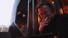 Mature businessman with gray beard focused on resolving work issues using tablet and stylus in modern urban setting. professional multitasking and digital technology in business problem-solving - Powered by Shutterstock - Get 15% off with code: PIKWIZARD15