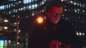 Mature man engaged with smartphone, exploring advanced technology. glow from screen reflects his focus on cutting-edge app, emphasizing innovation, connectivity, modern digital solutions in daily life - Powered by Shutterstock - Get 15% off with code: PIKWIZARD15