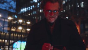 Mature man checking emails on smartphone app, immersed in convenience of mobile communication. illuminated screen highlights seamless technology and efficient digital tools for 5G connectivity - Powered by Shutterstock - Get 15% off with code: PIKWIZARD15