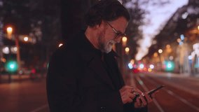 Smiling Mature man using smartphone for online banking, modern applications and convenience of fast 5G connection. Technology enhances efficiency in connected digital world, taxi app on cellphone - Powered by Shutterstock - Get 15% off with code: PIKWIZARD15
