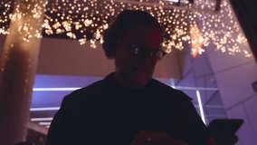 Mature man use smartphone to browse and select photos for sharing on social media or in chat. illuminated screen reflects ease of staying connected and sharing moments through modern digital platforms - Powered by Shutterstock - Get 15% off with code: PIKWIZARD15