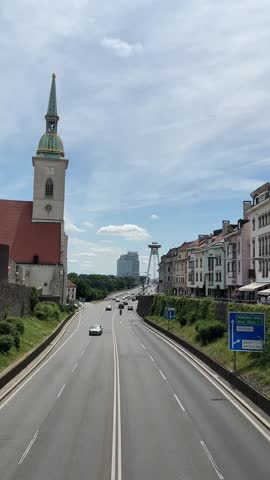 Church, colorful buildings, bridge in sunny Bratislava
