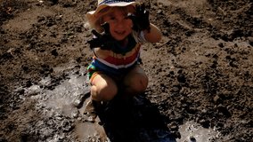 child dirty plays in mud. Selective focus. - Powered by Shutterstock - Get 15% off with code: PIKWIZARD15