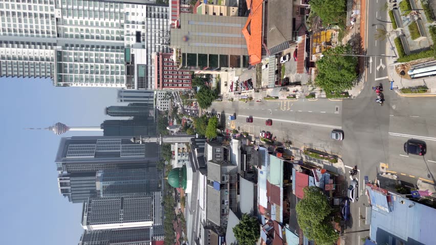 Vertical video. Aerial view of traffic in downtown Kuala Lumpur, Malaysia