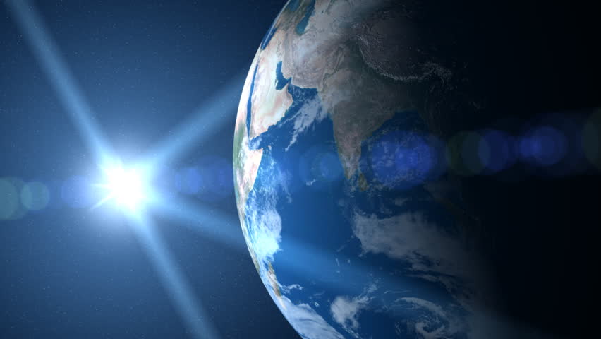 Earth sunrise - Camera pulls back to reveal sun over big blue Earth.