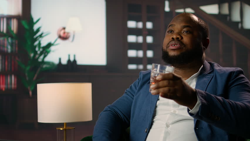 African american aristocrat drinking whiskey at the upper class country club, meeting with friends from the old money high society to discuss business and making a fortune. Camera A.