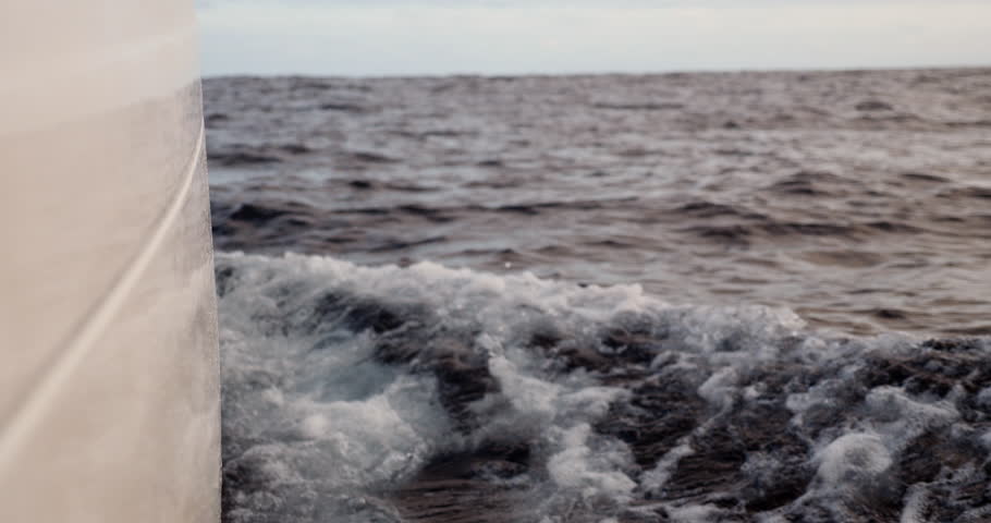 Starboard hul on a sailboat cutting trough the ocean while crossing the Bay of Biscay Stock Footage