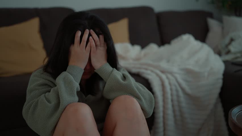 A young asian woman feeling depressed and stressed sitting head in hands, Lonely woman having life troubles