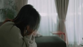 A young asian woman feeling depressed and stressed sitting head in hands, Lonely woman having life troubles - Powered by Shutterstock - Get 15% off with code: PIKWIZARD15