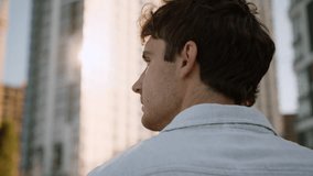 Back view close up Caucasian man turning head smiling happy cheerful enjoyment employee worker executive city entrepreneur leader male guy businessman business thinking standing outside smile downtown - Powered by Shutterstock - Get 15% off with code: PIKWIZARD15