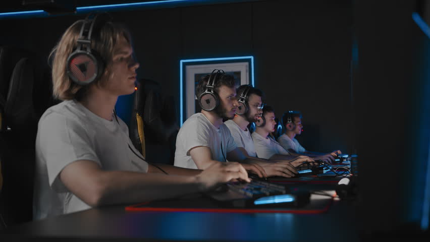 Win, gamer clutches the round in cyber tournament, player carries the map, emotions. Five guys play multiplayer online video game in computer club. Pro gamers play strategy shooter in LAN event