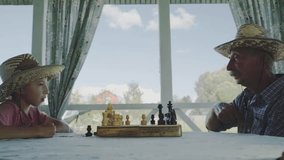 grandfather and grandson playing chess on the summer veranda - Powered by Shutterstock - Get 15% off with code: PIKWIZARD15