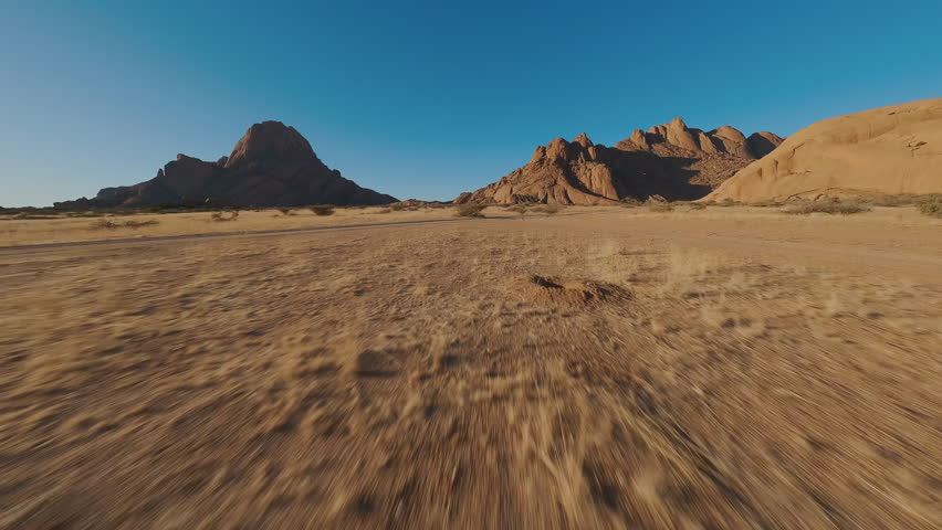 Mountains in sandy desert view from FPV drone