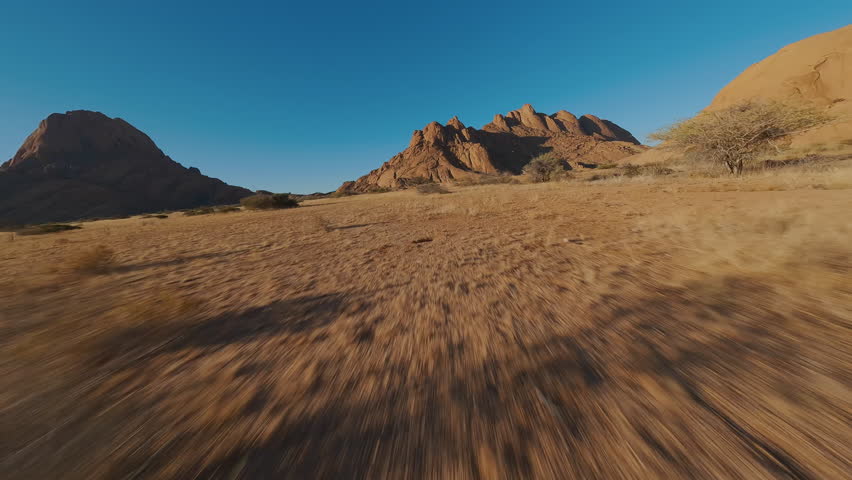 Mountains in sandy desert view from FPV drone
