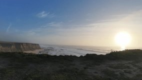 Wide-angle time-lapse of the Cowell-Purisima Trail in Half Moon Bay, California, showcasing ocean waves, rugged cliffs, and dynamic cloud movement during golden sunlight. - Powered by Shutterstock - Get 15% off with code: PIKWIZARD15