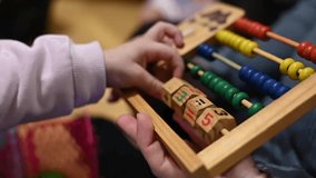mother teaches her daughter to count with an abacus - Powered by Shutterstock - Get 15% off with code: PIKWIZARD15