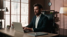 Serious concentrated Caucasian businessman in office business man male guy employer working laptop typing work online internet job computer pc consulting client marketing web trade company corporate - Powered by Shutterstock - Get 15% off with code: PIKWIZARD15