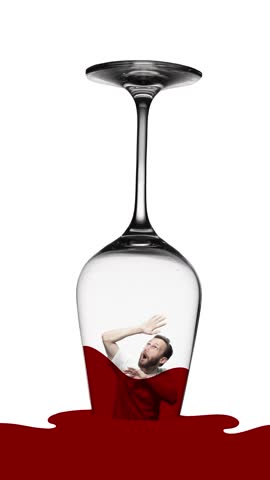 Anxious man stuck into glass with red wine. Suffering from male alcoholism and problems. Conceptual design. Concept of addiction, alcoholism, medical treatment, healthcare. Stop motion, animation