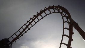 Roller coaster Ride against Roller coaster in the amusement park. - Powered by Shutterstock - Get 15% off with code: PIKWIZARD15
