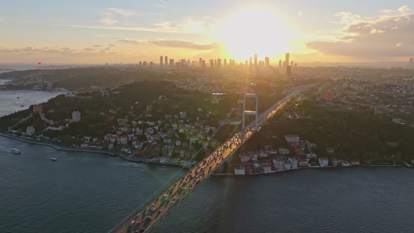 Aerial view of Fatih Sultan Mehmet Bridge over the Bosphorus river at sunset with a beautiful skyline, Istanbul, Turkey.