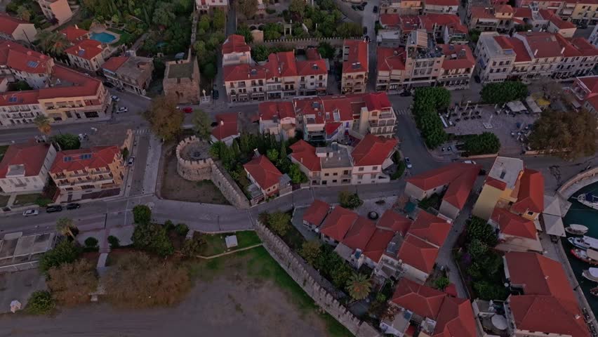 Aerial view of Nafpaktos Venetian Port at sunrise with historic fortress and charming old town, Nafpaktos, Greece.