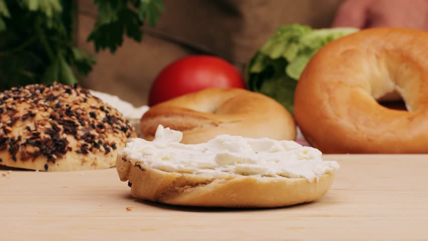 Bagel sandwich brunch, lunch plate of a bagel with smoked salmon and cream cheese and ham, close up morning cafe menu.