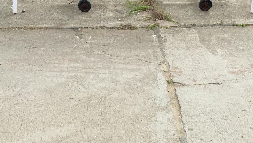 No parking sign board at the concrete, A no parking sign in front of a gated house. A warning prohibiting vehicles blocking the gate or the side of the road.