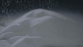 Sugar granules falling in slow motion creating a soft pile under dramatic low light - Powered by Shutterstock - Get 15% off with code: PIKWIZARD15