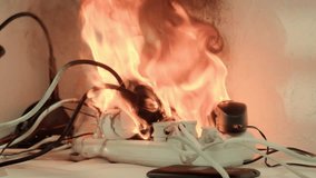 Electrical power cube strip sockets smoking and burning on fire desk indoors due to overload from connected electrical appliances. - Powered by Shutterstock - Get 15% off with code: PIKWIZARD15