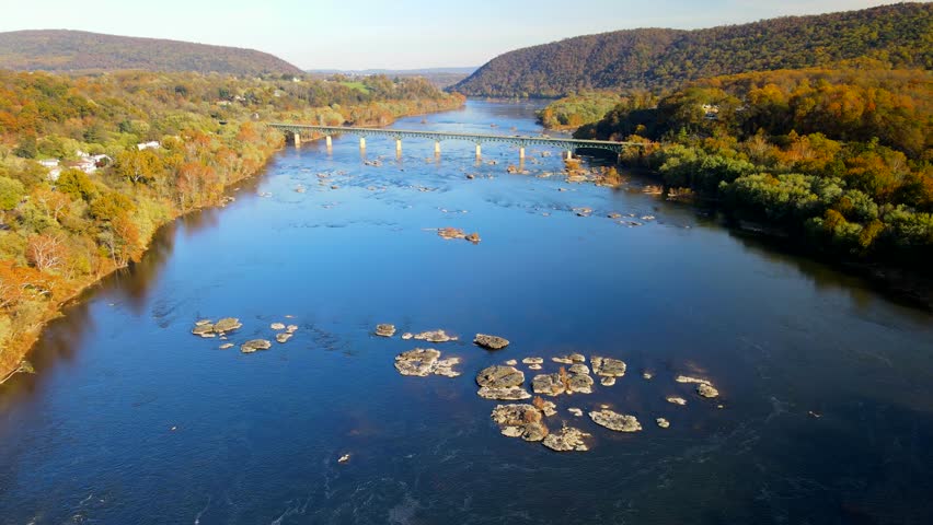 automobile bridge over the Potomac River in Virginia. Autumn landscape. View from drone, traffic along the river.