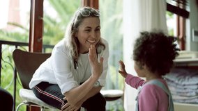 Doctor, high five and fist bump with child at hospital for healthcare consultation. Pediatrician, hand and medical professional with kid for happy emoji, gesture and playing with patient at clinic. - Powered by Shutterstock - Get 15% off with code: PIKWIZARD15