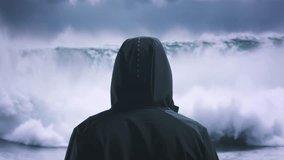 Hooded Figure Watching Ocean Waves Storm Clouds Dark Moody Nature Power - Powered by Shutterstock - Get 15% off with code: PIKWIZARD15
