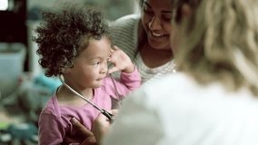 Doctor, stethoscope and pediatrician with women and baby for medical, family medicine and advice. Healthcare, nurse and wellness with mother and child in clinic for playful, heart beat and check up - Powered by Shutterstock - Get 15% off with code: PIKWIZARD15