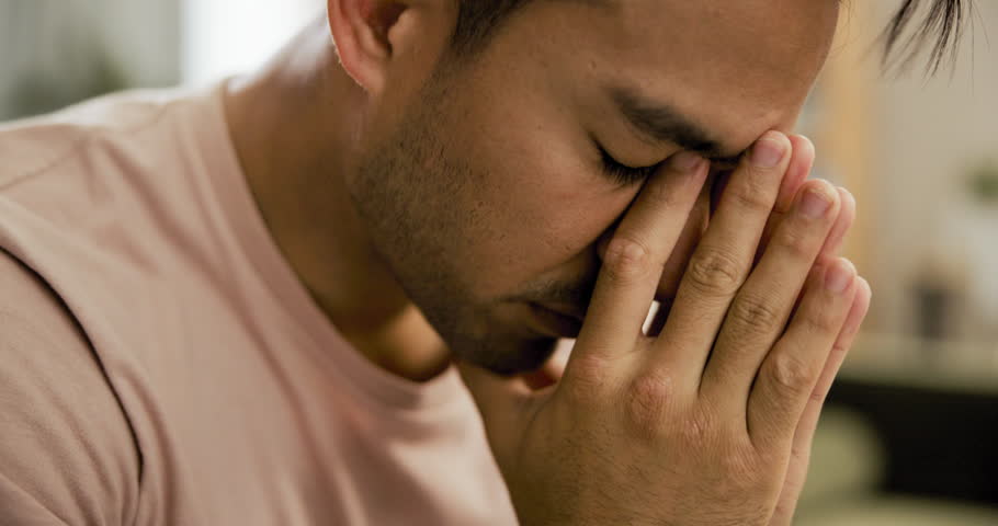 Pain, regret and depression with a man in therapy for mental health, psychology or healing closeup. Stress, anxiety and mistake with a young patient in a grief counseling session for loss or sad