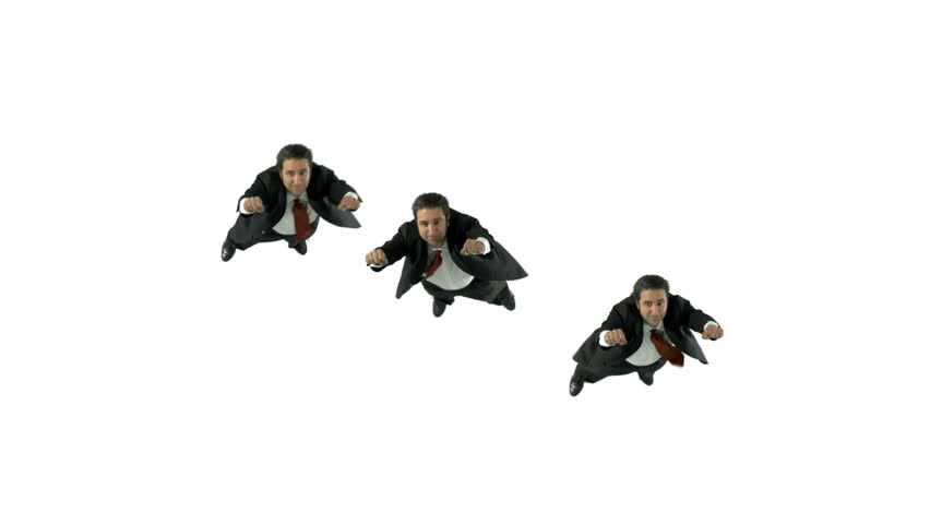 Formation of men in business suits flying in front of a white background.