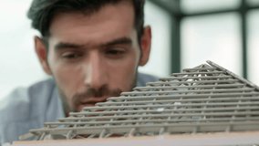 Professional architect engineer using pencil measuring model roof length at modern office with skyscraper, cityscape view. Skilled project manager or businessman check house construction. Tracery - Powered by Shutterstock - Get 15% off with code: PIKWIZARD15