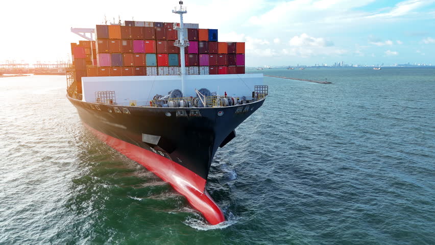 Front view of Cargo container ship carrying container and running out international container port customs shipyard sea port concept smart logistic service.