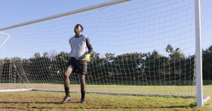 Goalkeeper in soccer uniform standing in goal, ready to defend shot. Sports, athlete, defense, teamwork, competition, training - Powered by Shutterstock - Get 15% off with code: PIKWIZARD15