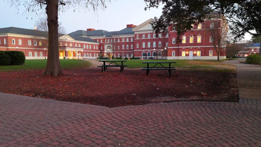 Rising over educational buildings as the sun sets behind