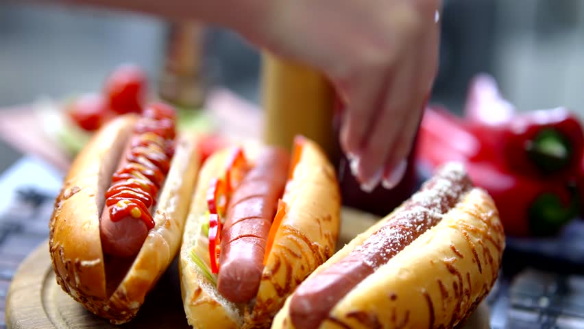 Hot Dog Served Mustard And Ketchup. American Fast Food. Tasty Hot Dog With Grilled Sausage. Appetizing Street Food. Grilled Sausage Hot dog Junk Food. Adding Ketchup And Mustard To Tasty Hot Dog Meat