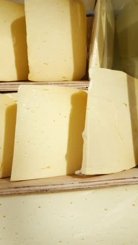 many type of cheeses on shop window