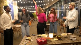 Blonde woman dancing among multi-ethnic friends at night party in a bar terrace in the city - Powered by Shutterstock - Get 15% off with code: PIKWIZARD15