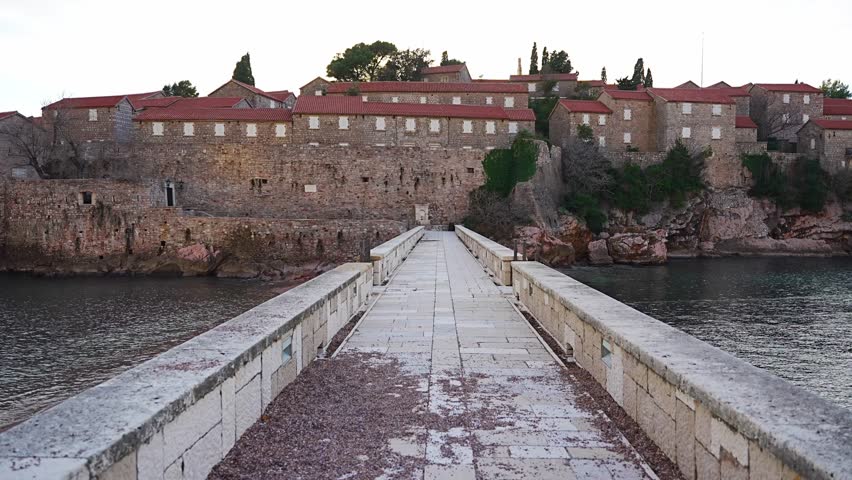 Sveti Stefan island near Budva at sunset light in winter time. Closed resort in Montenegro. High quality 4k footage