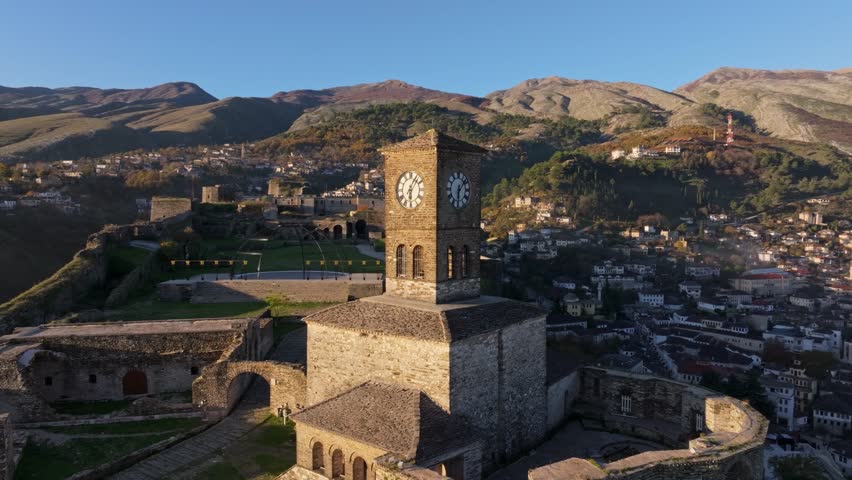 Aerial view of the castle of Gjirokaster at sunrise with scenic mountains and old town, Gjirokaster, Albania.