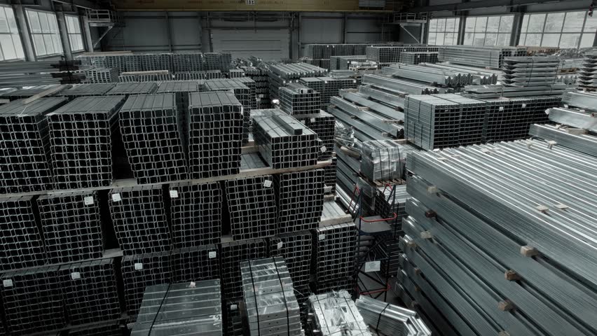 Large warehouse of finished products. Parts for road infrastructure. Galvanized steel fences and supports, ready for shipment.