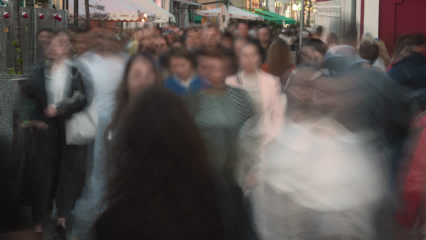 People crowd walk city street time lapse. Lots of busy pedestrians hurry up home, work timelapse. Metropolis rush hour. Life transience concept. Fast urban road. Many citizen run, stroll public place.