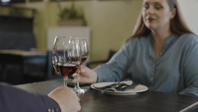 Slow motion highlights of a woman enjoying wine with a business partner in a cozy restaurant setting - Powered by Shutterstock - Get 15% off with code: PIKWIZARD15