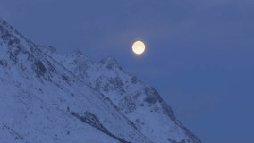 Bright full moon looms over snow covered mountain in Lofoten, Norway, majestic natural arctic scenery - Powered by Shutterstock - Get 15% off with code: PIKWIZARD15