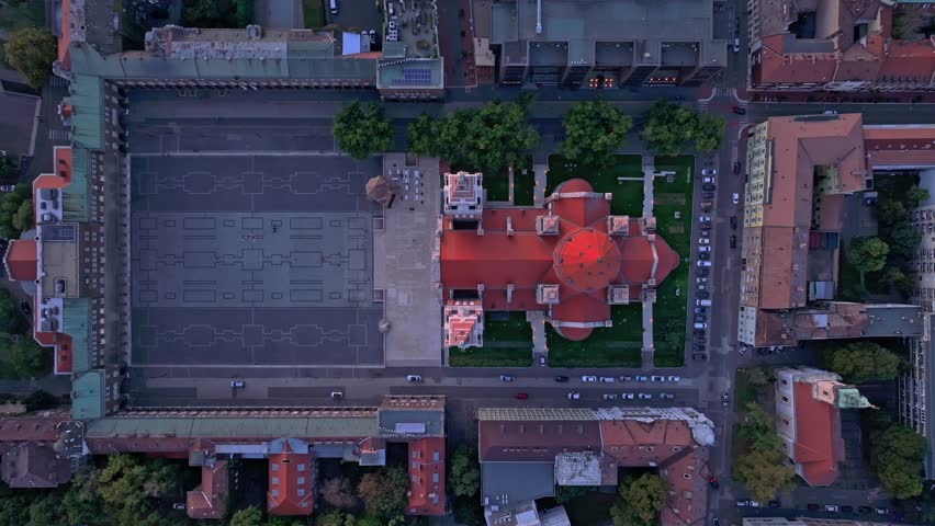 Aerial view of Szegedi Dom cathedral at sunset surrounded by beautiful urban landscape and historic buildings, Szeged, Hungary.